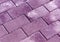 Violet color cobblestone pavement texture.