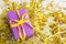 Violet elegant present with yellow ribbon on golden tinsesl and garland