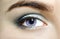 Violet eyes mutation eyes, Close Up. The human eye of a woman with light beauty cosmetics and long natural eyelashes. Girl with