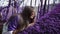 Violet fairytale forest. Beautiful girl in a lilac jacket is sleeping on a soft purple moss in the middle of an
