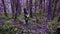 Violet fairytale forest. Walking in the enchanted purple forest, girl has found the stump, went to it and sat down for