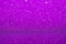 Violet glitter surface. Purple shimmer background in soft focus. Sparkling wrapping shiny paper.