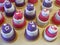 Violet and grenadine cupcakes in form of the mini wedding cakes