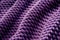 Violet knitted fabric surface abstract background.