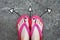 Violet Nail Pedicure. Womanâ€™s Sandals Feet with Arrows Drawn Choices Direction on Cement Background