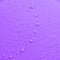 Violet pastel water drops on light shiny surface