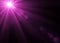 violet pink lens flare in black background