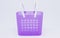 Violet plastic basket with white handles.