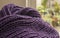 A violet/purple scarf, lines of the pattern on the folds.