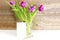 Violet purple tulips colorful bouquet in vase.Beautiful tenderness flowers,gift,close up.Spring floral romantic blank