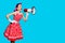 Violet red haired woman using mega phone, shouting something. Pin up girl. copy space. aqua blue background
