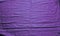 Violet textured vibrant cloth with folds. Abstract backdrop. Wallpaper