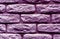 Violet toned brick wall surface.