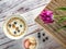 Violet tulip on wooden box and top view to bowl with cereals and capcakes