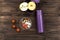 Violet vacuum bottle lying on the wooden table