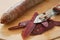 Violets carrots and peelings on wooden cutting board