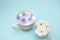 Violets and white flowers in milk water in a cup. Beauty and wellness treatments with flower petals in a milk bath, skin care.