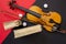 Violin, bow and books on a red-black background