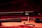 Violin and bow in dark red case. Close up view of a violin strings and bridge