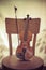 violin and bow, stand on an old wooden chair. Concept art. Vintage style toned photo