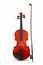 Violin with bow upright on whi