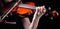 Violin classic musical instrument. Classic player hands on a black background. Details of violin playing