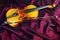 Violin on a color background. Violin on a purple silk background.