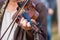 Violin in the hands of a musician during a concert