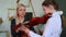 Violin lesson - blonde woman teaching little girl how to hold a violin