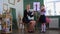 Violin lesson - a little girl playing violin standing in the class and her teacher sitting next to her and fixing her