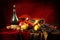 Violin and Masquerade Mask on a red background next to a bottle of old wine and fruit