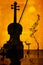 Violin on orange background with reflective surface. Sultry music