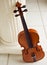 Violin standing against column