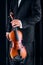 Violinist with elegant suit taking a violin