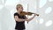 Violinist performs a musical composition on a violin in a studio