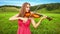 Violinist Plays on a Green Meadow