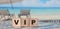 VIP Very Important Person text on wooden cubes on ocean beach. Business concept