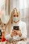 Viral mask. European blonde in flu mask for prevention. phone in hands emergency phone