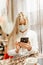 Viral mask. European blonde girl in flu mask for prevention. Looking at the phone