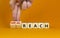 Viral reach symbol. Businessman turns wooden cubes and changes words `reach` to `viral reach`. Beautiful orange table, orange