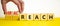 Viral reach symbol. Businessman turns wooden cubes and changes words `reach` to `viral reach`. Beautiful yellow table, white