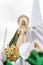 Virgin of Hope behind a penitent in the procession of the Brotherhood of the Virgin of Hope in Holy Week in Zamora, Spain
