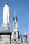 Virgin Mary and basilica in pilgrim town Lourdes