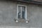 Virgin Mary figurine in an old, dusty window.