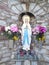 Virgin Mary grotto flowers pink white yellow burgundy