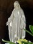 Virgin Mary Statue, light and shadow in church garden