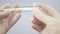 A virologist puts a cotton swab into a test tube to examine a smear from the lungs. A doctor takes a sample from the