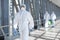 Virologists wearing protective hazmat suits making researches