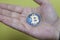 Virtual blue coins bitcoins holding hand
