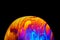 Virtual reality space with abstract multicolor psychedelic planet. Closeup Soap bubble like an alien planet on black background